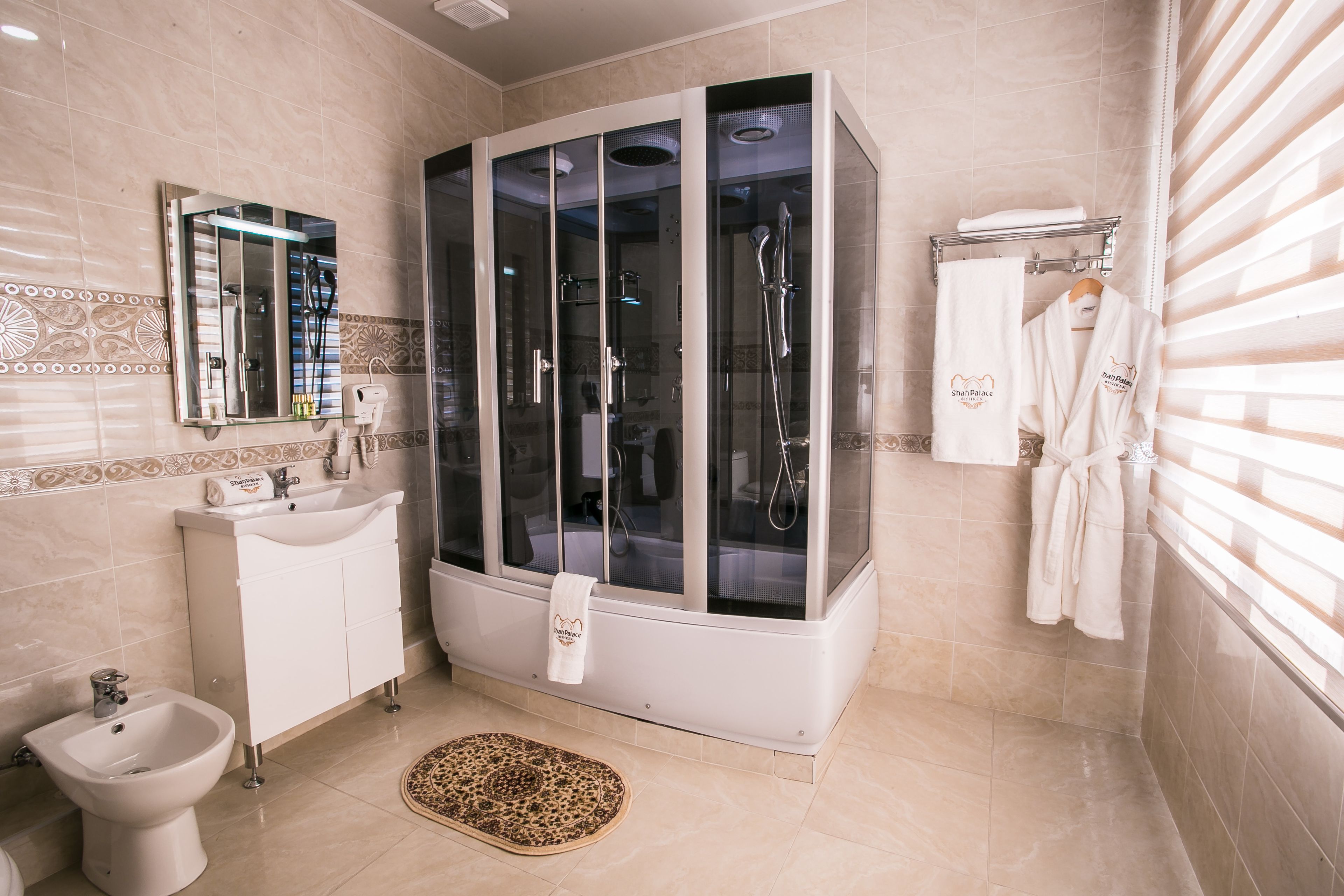 deluxe king room | bathroom | free toiletries, hair dryer, slippers, towels