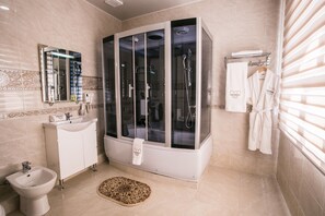 Deluxe King Room | Bathroom | Free toiletries, hair dryer, slippers, towels