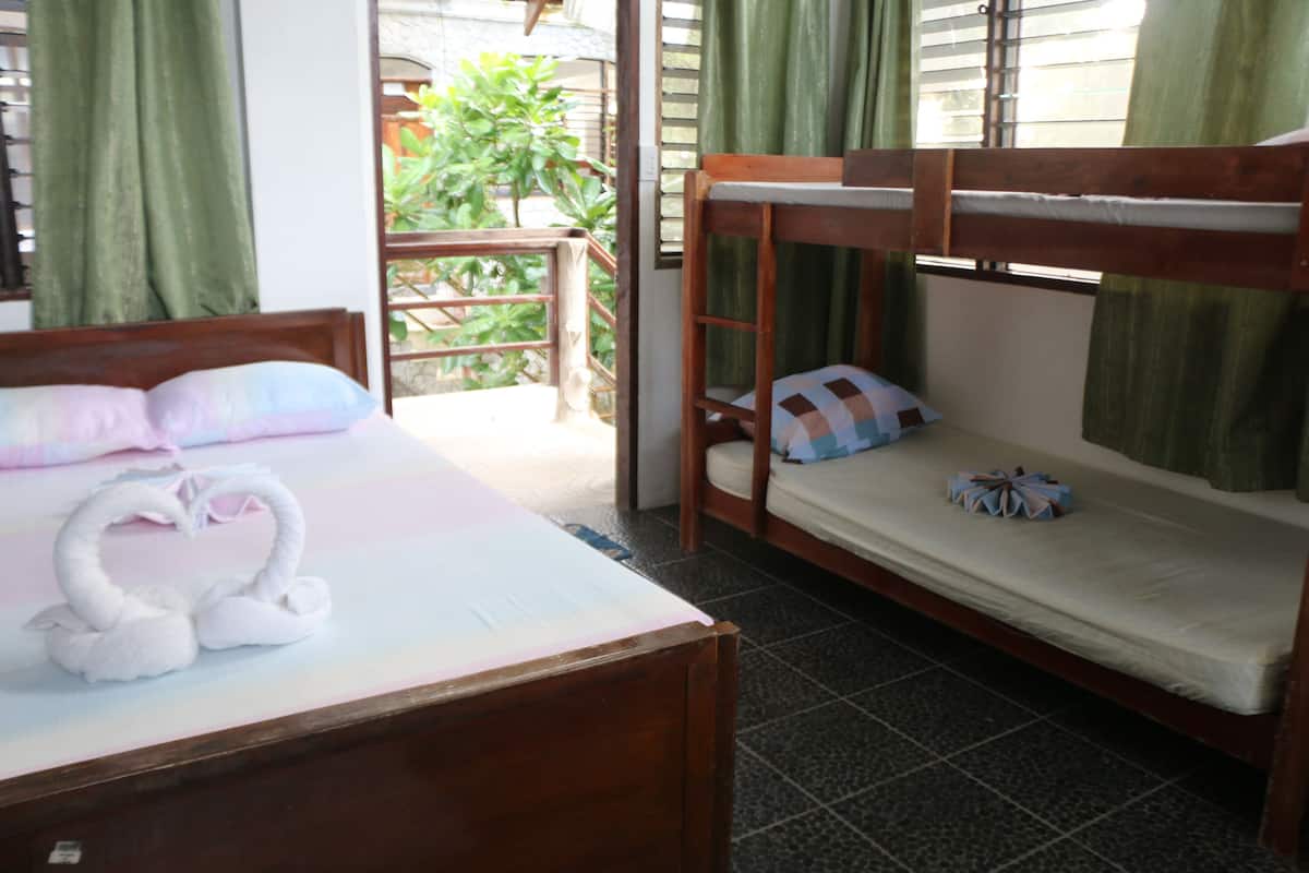 A bunk bed with a mattress and pillows, a wooden headboard, and a swan-shaped decoration on the bed.