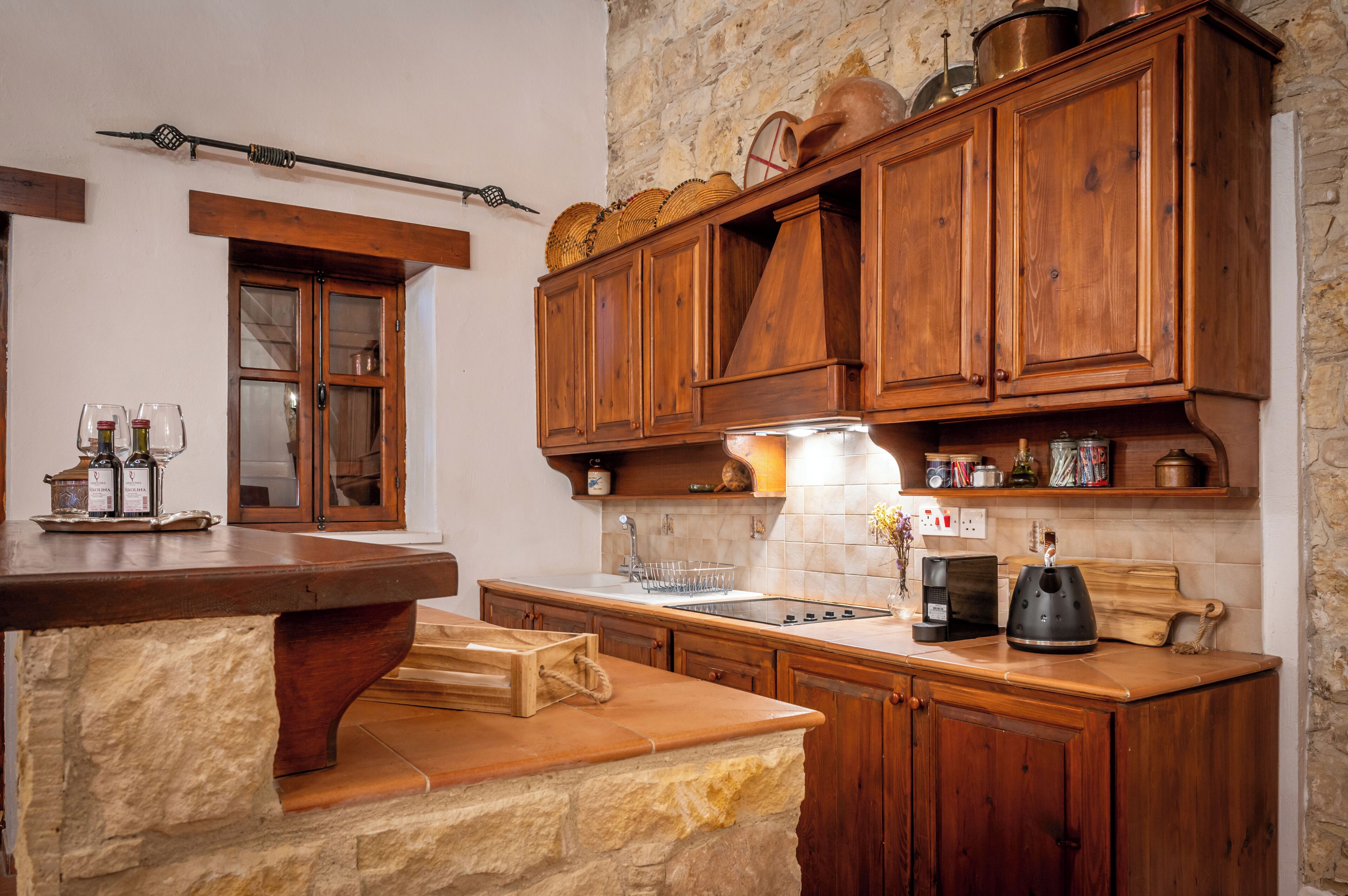A kitchen with wooden cabinets, a stone countertop, and a built-in stove.
