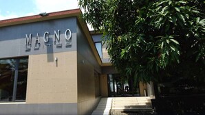 A building with a sign reading "MAGNO" on the facade. - Magno Suites (Malabo)
