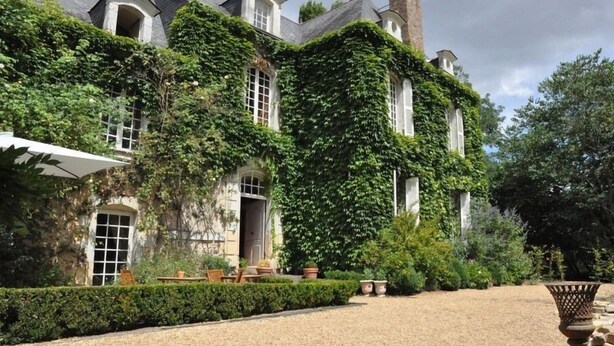 A large, ivy-covered building with multiple windows and a gravel driveway. - La Marronnière (Cheffes)
