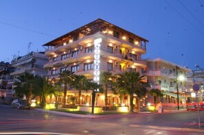 A multi-story hotel with balconies, palm trees, and a well-lit facade. - Tropicana (Katerini)