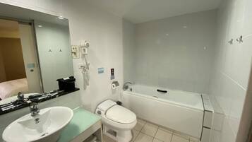 Une salle de bain moderne avec un lavabo, des toilettes et une baignoire.