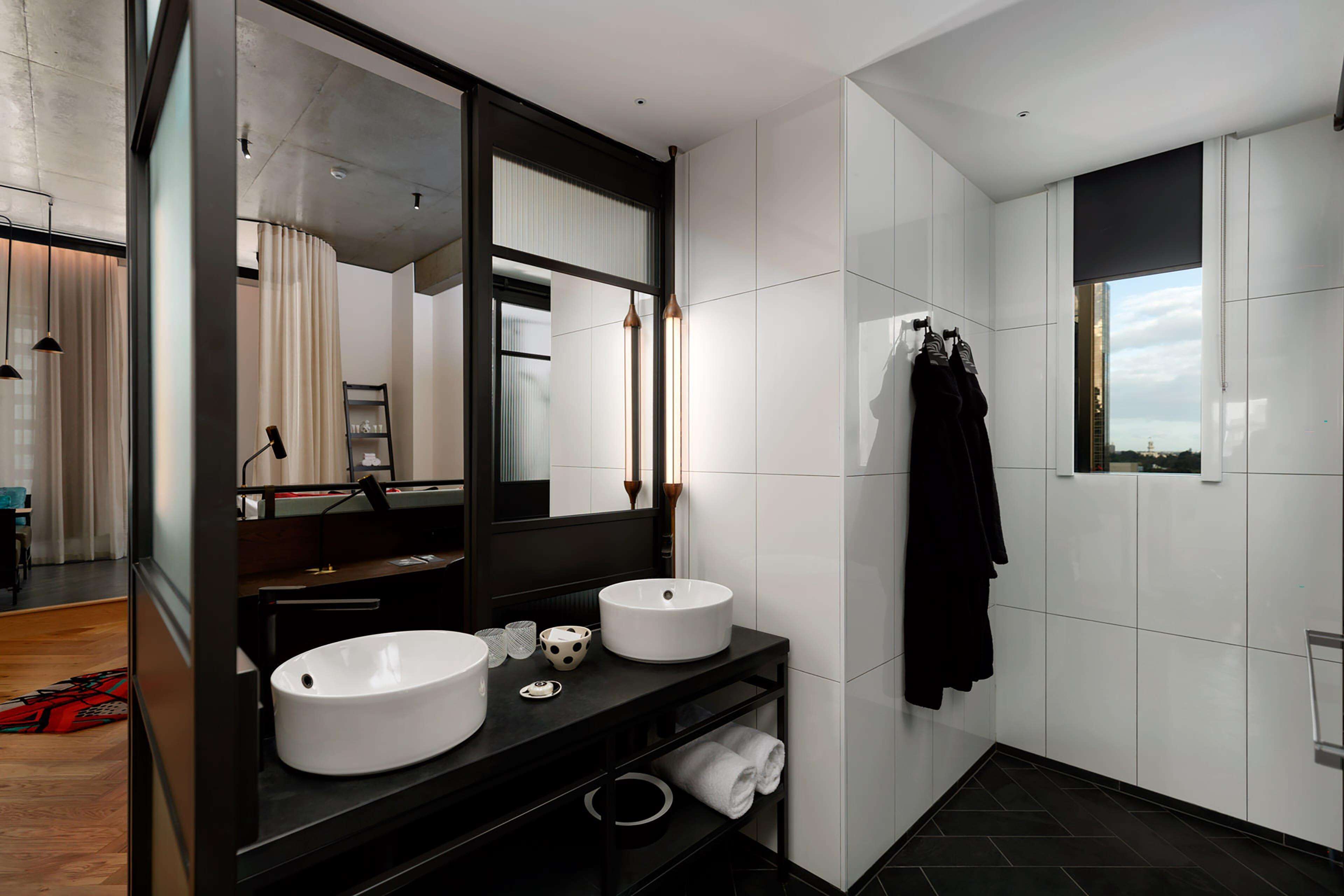 qt corner king room | bathroom | rainfall showerhead, designer toiletries, hair dryer, bathrobes