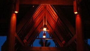 A wooden structure with a central hanging light fixture, likely a part of a building's interior. - Emerald Land Hotel (Mandalay)