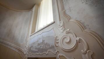 A detailed architectural ceiling with ornate carvings and a window.