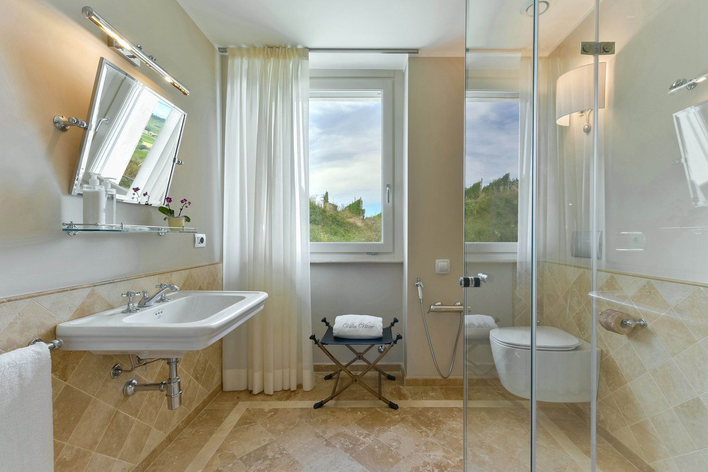 A bathroom with a sink, mirror, and toilet.