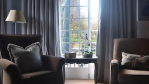 Family Cottage, 3 Bedrooms (Ambleside) | Living area | Flat-screen TV, fireplace - Ambleside Clarens Self Catering Cottages (Clarens)