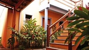 A staircase leading up to a building with a wooden handrail and a stone pathway. - Pousada Conchas de Paraty (Paraty)