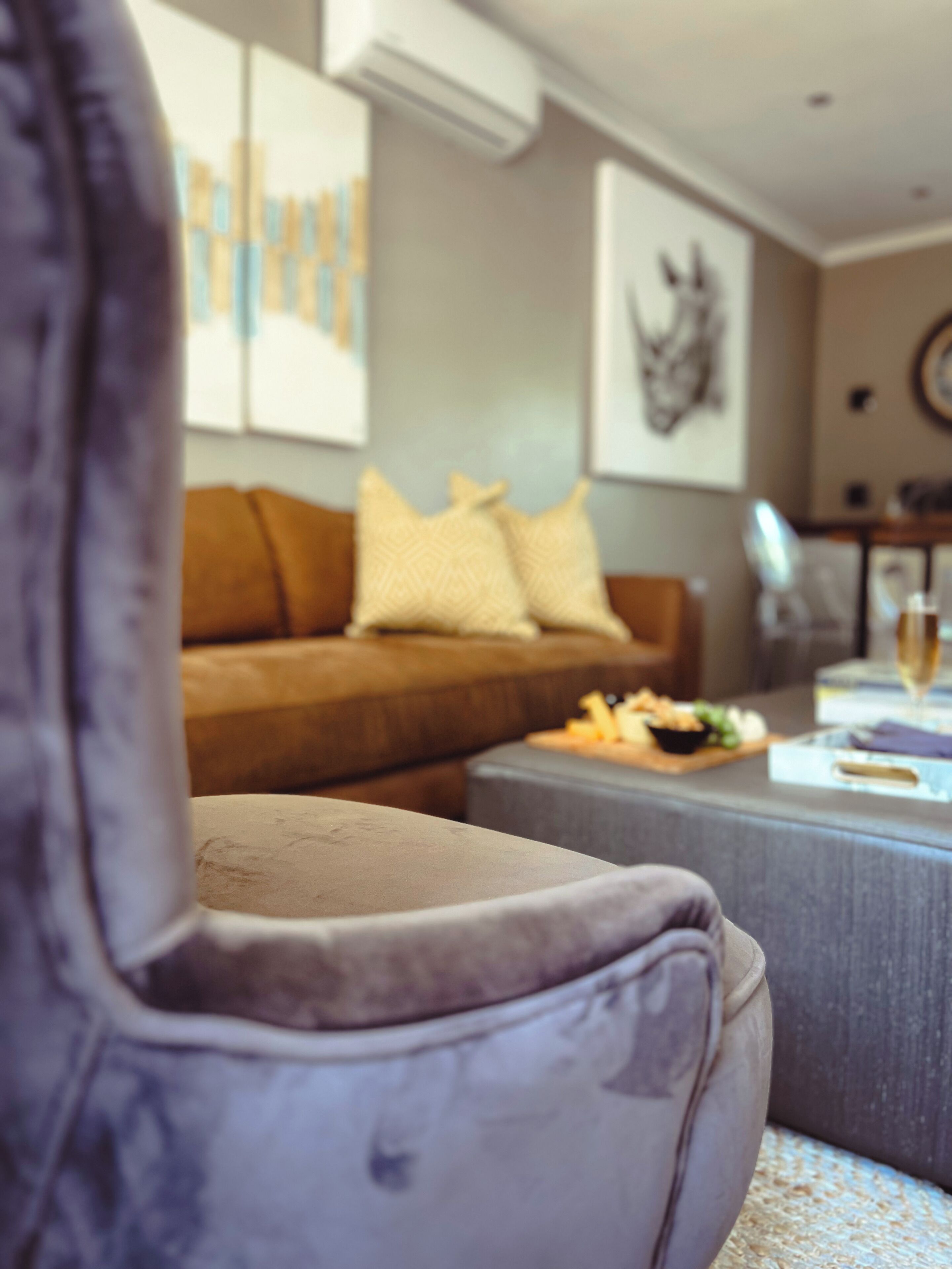 A living room with a sofa, a coffee table, and a decorative wall piece.
