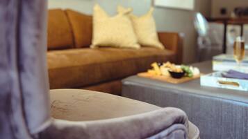 A living room with a sofa, a coffee table, and a decorative wall piece.