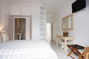 A bedroom with a bed, a desk, a chair, a TV, and a wardrobe. - Rivendell Bed and Breakfast (Hillcrest)