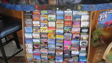 A travel information desk with a variety of guidebooks and maps for different destinations.