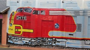 A mural of a red train with the number 347C on a wall. - El Trovatore Motel (Kingman)