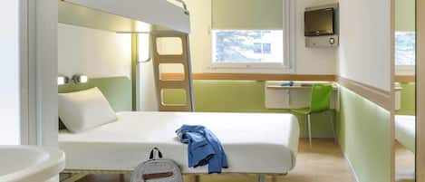 A compact hotel room with a bunk bed, a desk, a chair, a TV, and a bathroom.