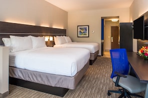 A hotel room with two beds, a desk, a chair, a TV, and a painting on the wall.