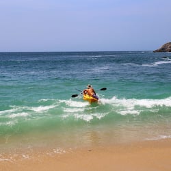 On the beach, white sand, sun-loungers, beach umbrellas