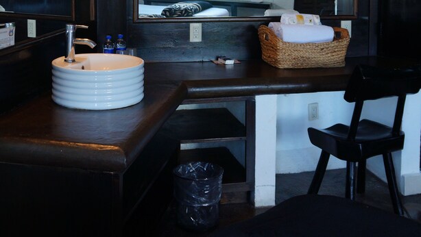 A bathroom with a sink, mirror, and a large window with curtains. - Hotel Casa Blanca San Miguel (San Miguel de Allende)