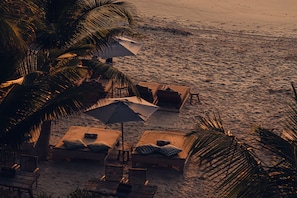 On the beach, white sand, free beach cabanas, sun-loungers