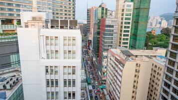 A high-rise building with multiple floors, large windows, and a busy street below.