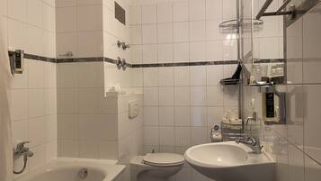 A modern bathroom with a bathtub, toilet, and sink.