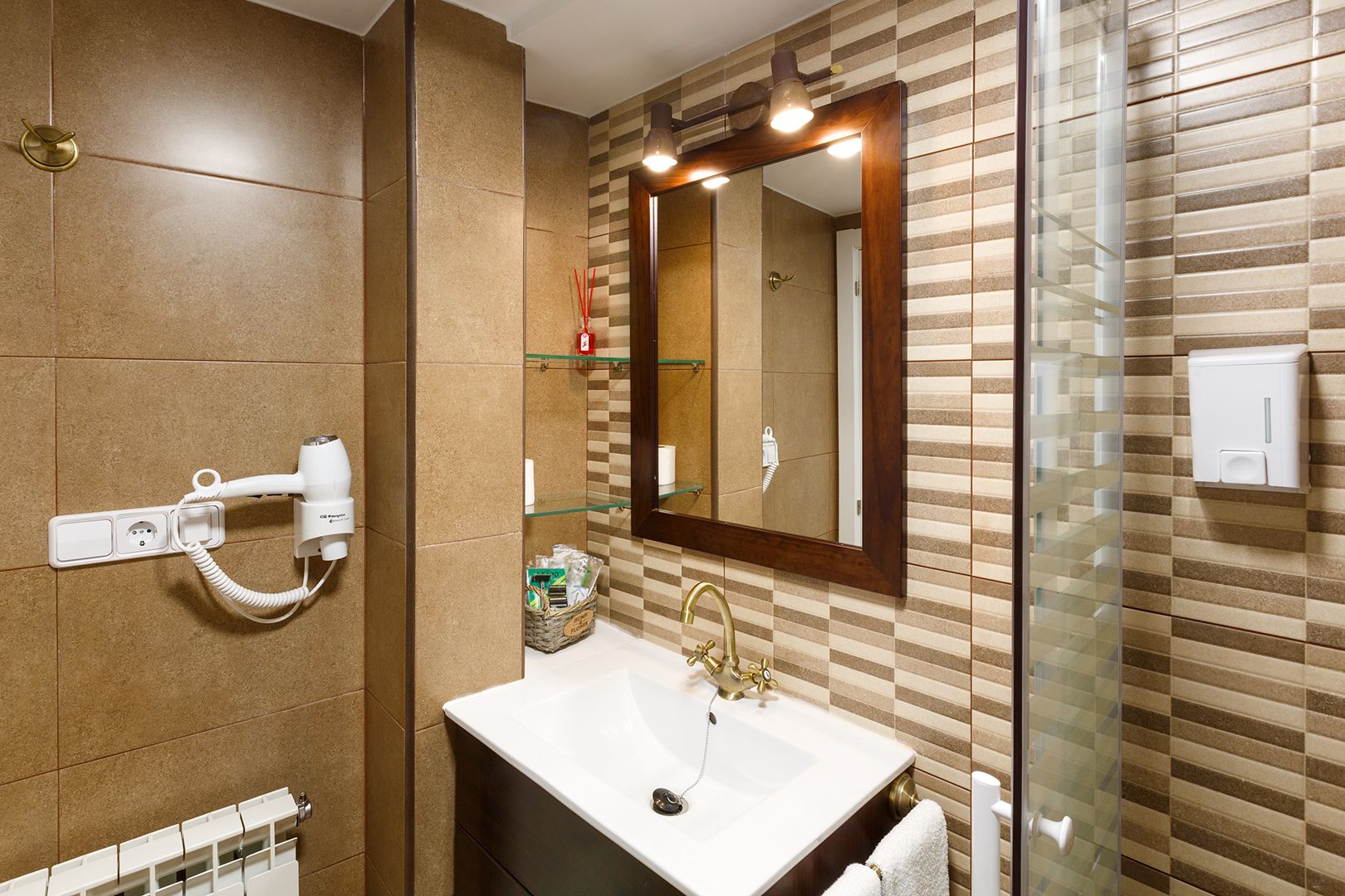 A modern bathroom with a large mirror, a sink, and a hairdryer.