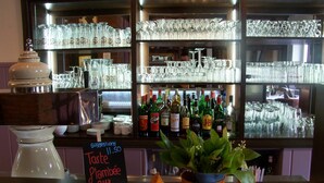 A bar area with shelves of glassware and bottles of liquor. - Hotel le Falken (Philippsbourg)