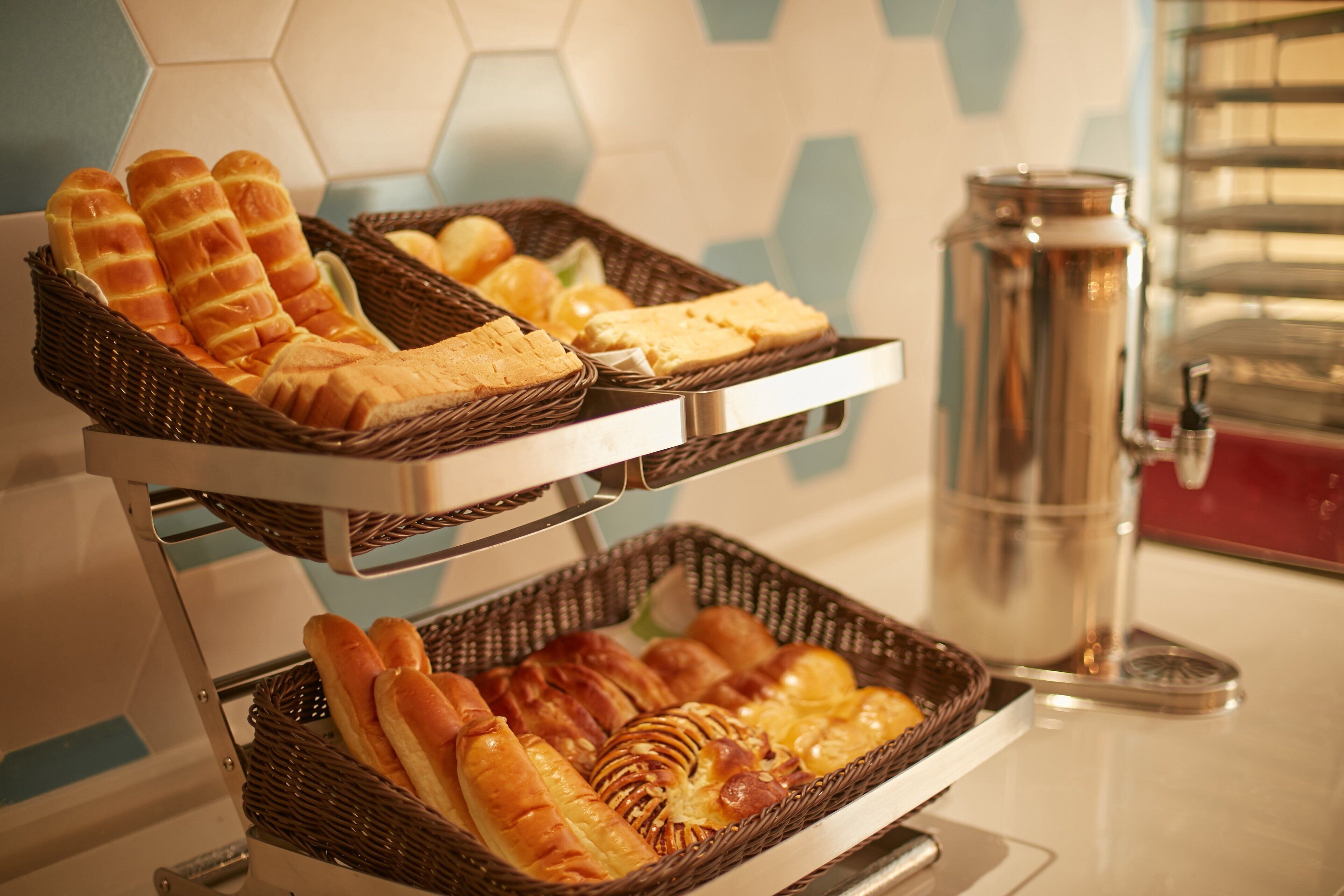 A buffet setup with various breads and pastries.