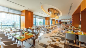 A spacious restaurant with high ceilings, large windows, and a checkered floor.
