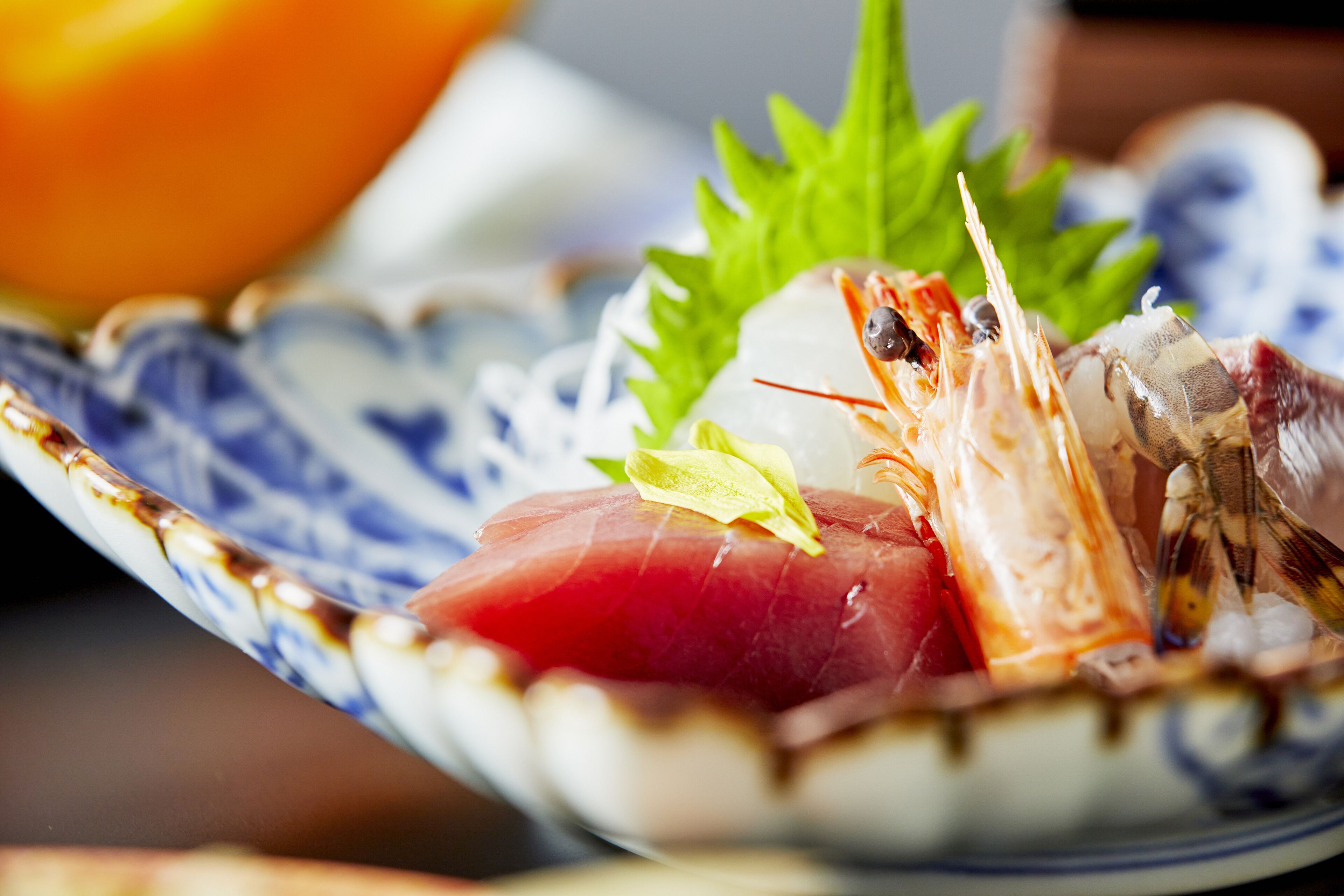 A close-up of a seafood dish on a ceramic plate.