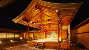Een traditioneel Japans gebouw met een houten podium en een schilderachtige muur.