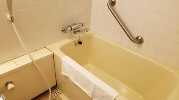 A bathroom with a bathtub, a shower, and a toilet.