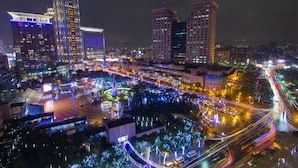 A nighttime cityscape with illuminated buildings and busy streets. - ChengDian Hotel (New Taipei City)