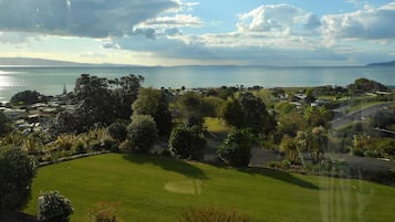 A coastal landscape with a golf course, houses, and a view of the sea.