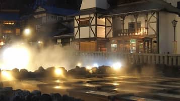A traditional Japanese building with a wooden facade and a sign above the entrance.