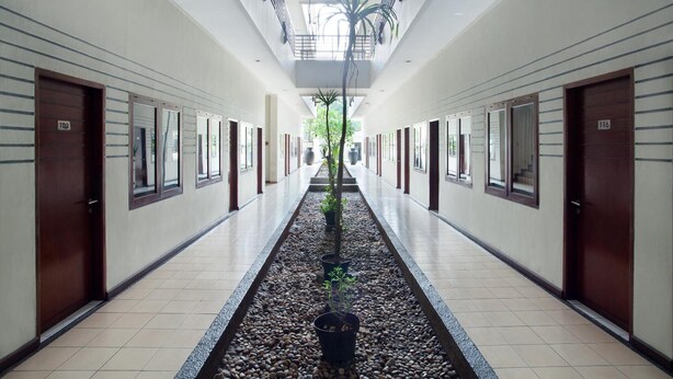 A corridor with doors numbered 102 and 116, leading to rooms. - N Hotel Harmoni Jakarta (Jakarta)