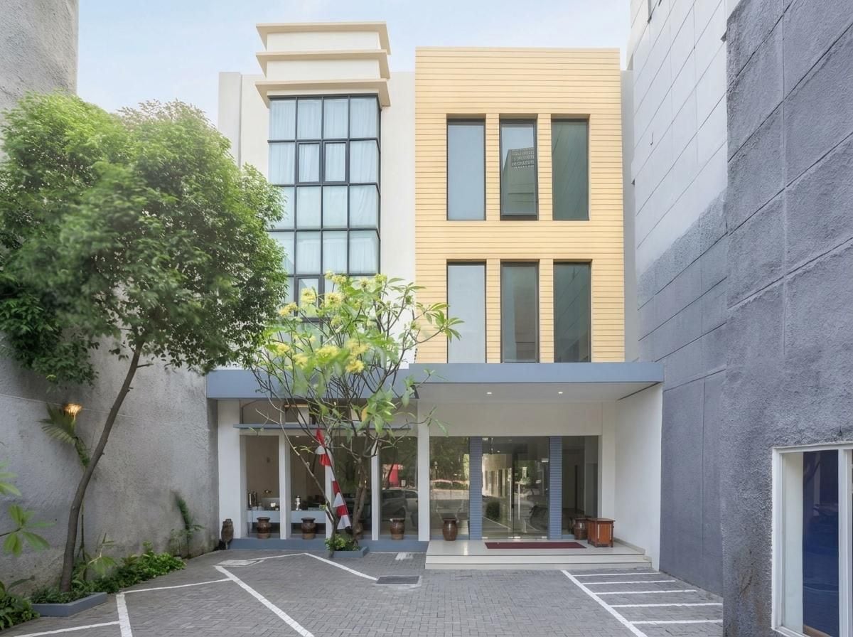 A modern building with a courtyard, large windows, and a flat roof.