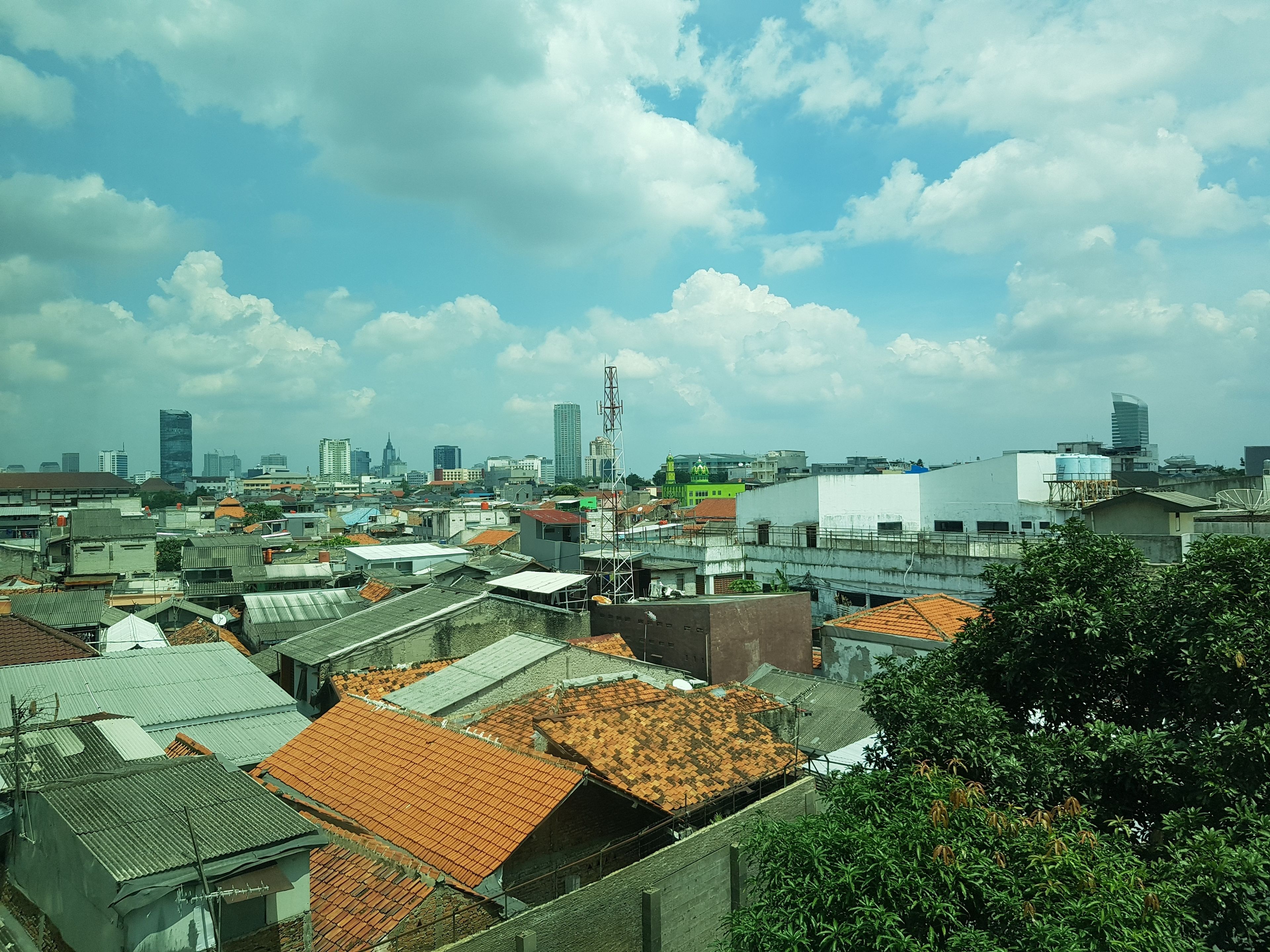 A cityscape with various buildings, including residential and commercial structures.