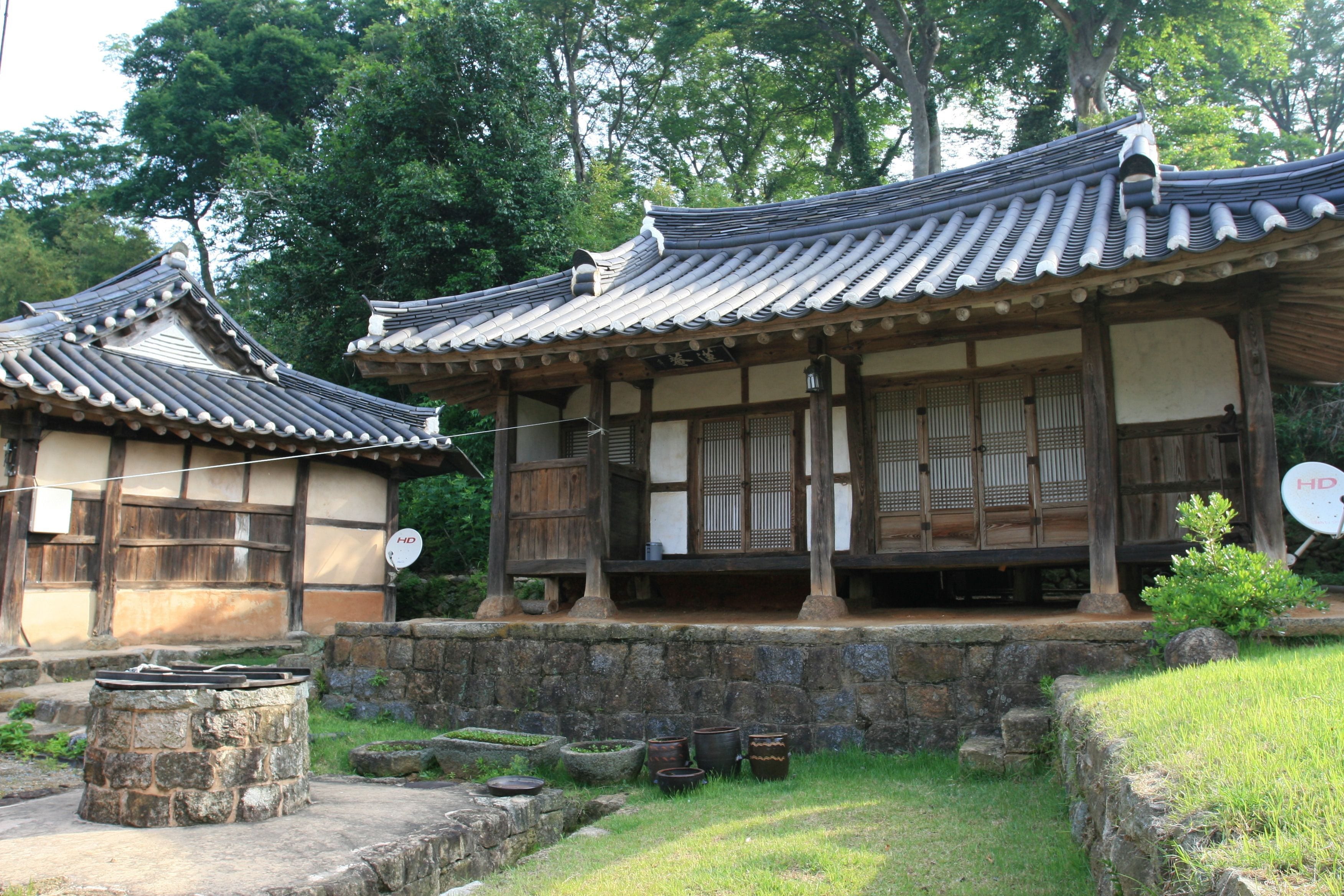 A traditional Japanese building with a tiled roof and wooden structures.