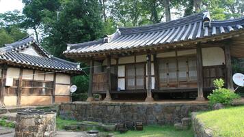 A traditional Japanese building with a tiled roof and wooden structures.