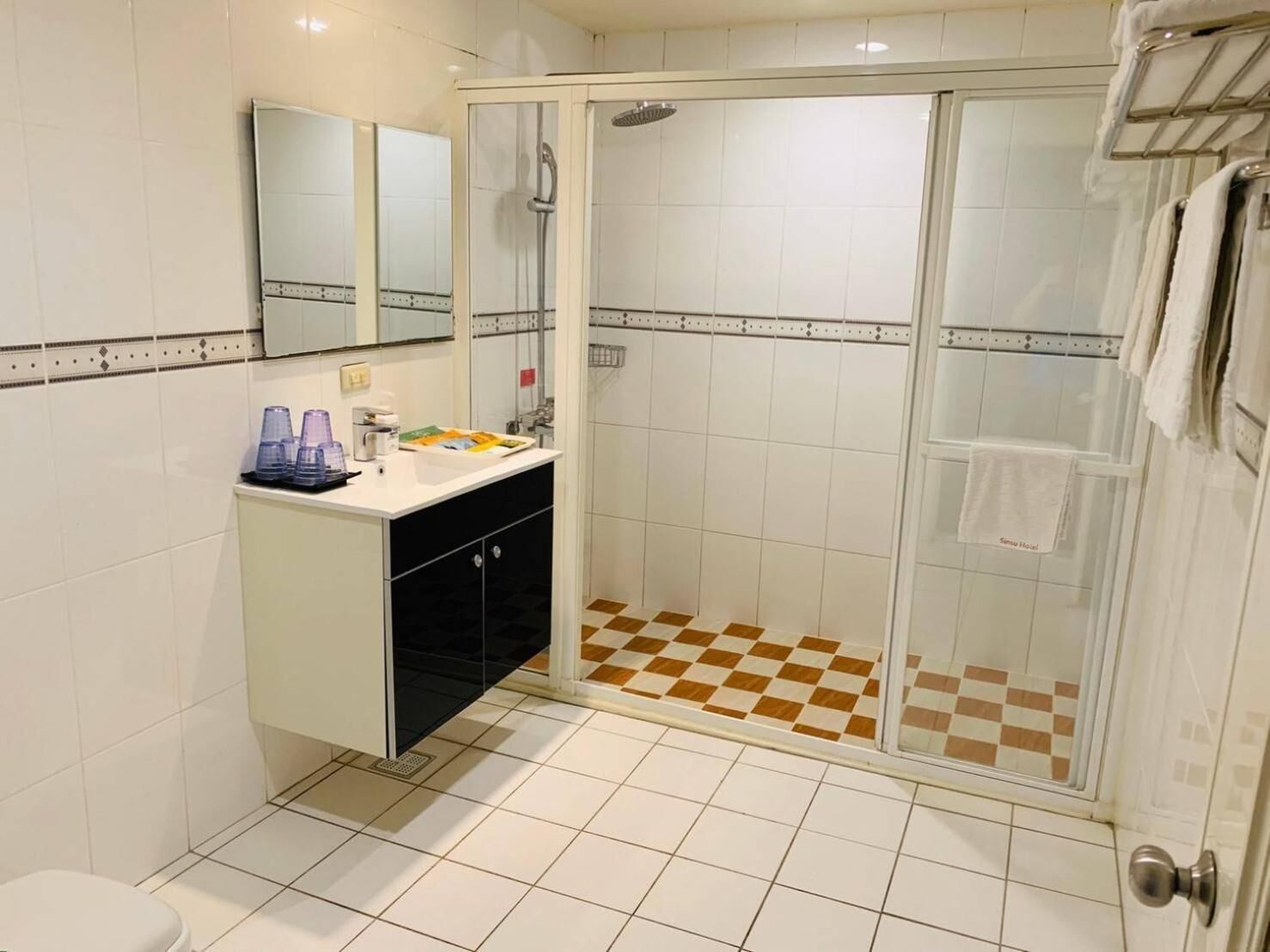 shower, hair dryer, slippers, towels