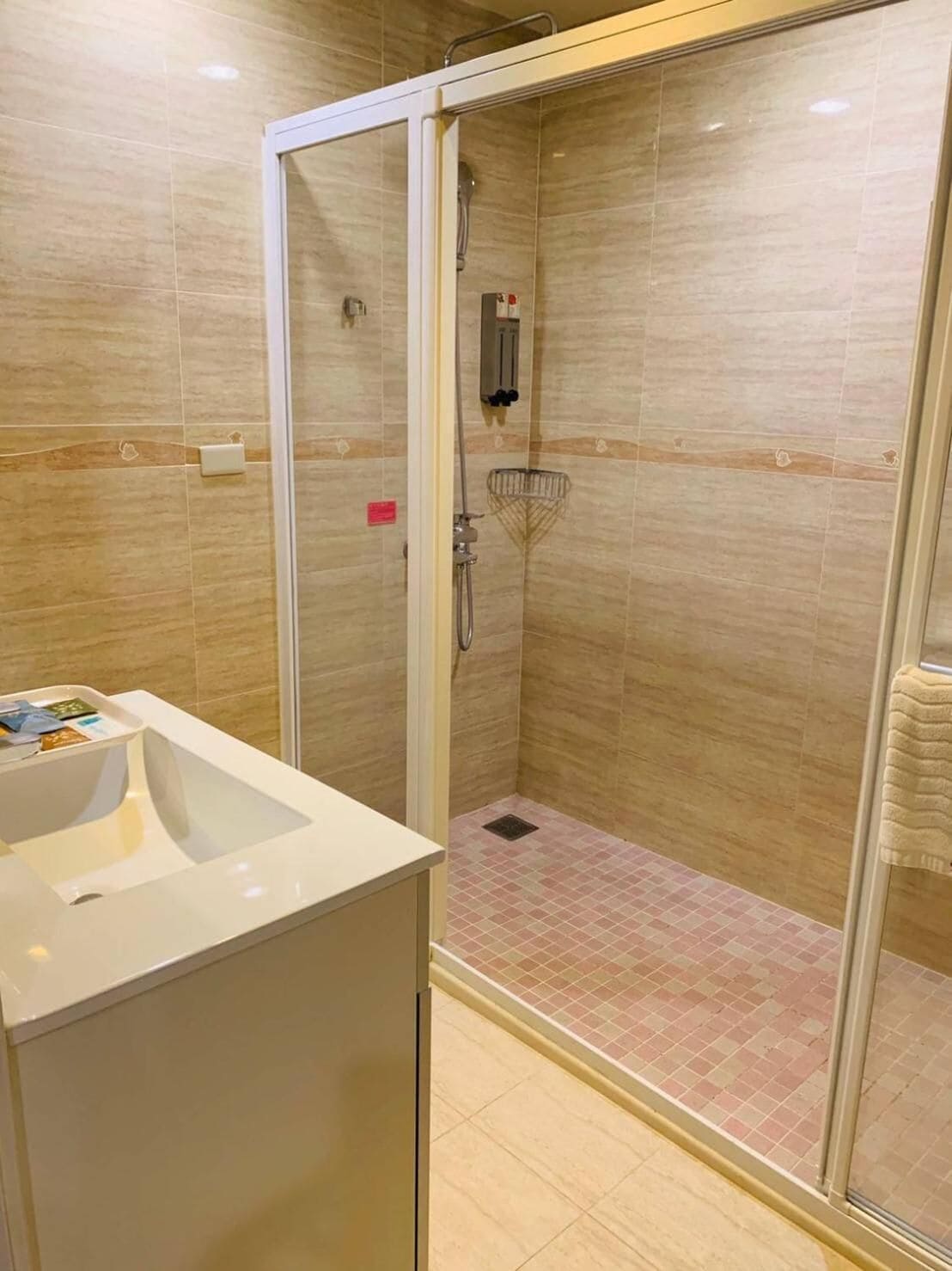 shower, hair dryer, slippers, towels