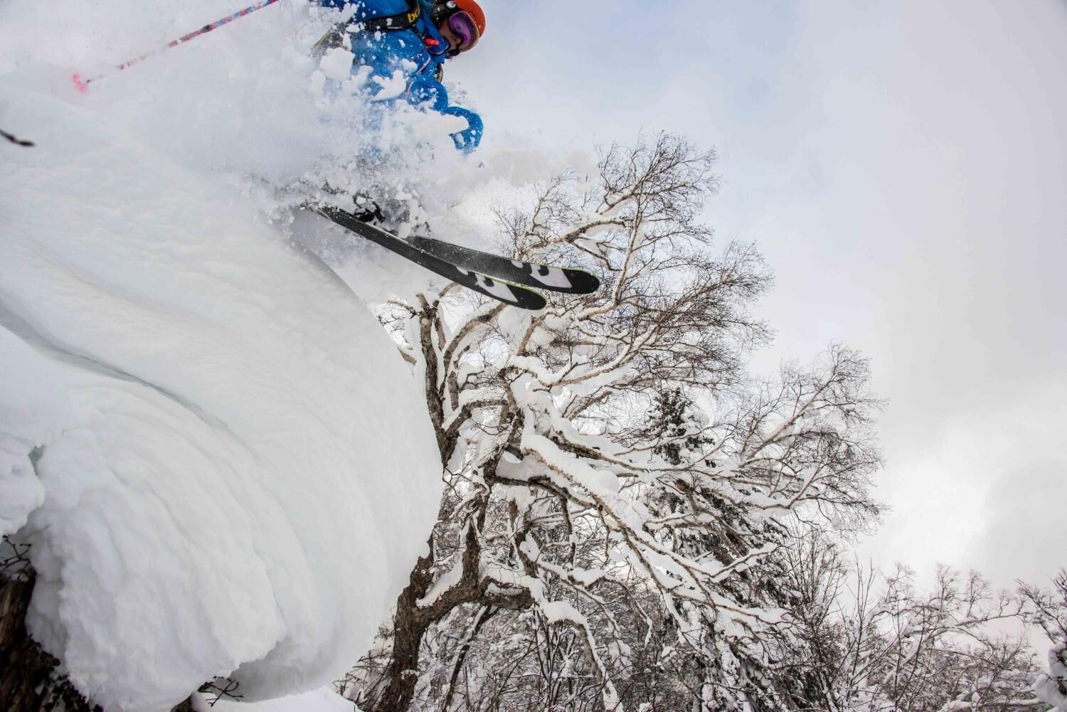 A snowy landscape with a skier in motion.