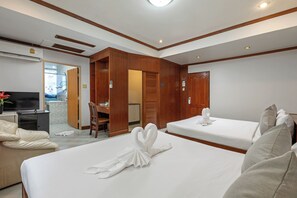 A hotel room with two beds, a TV, a desk, and a bathroom. - Break Point Patong Hotel (Patong)