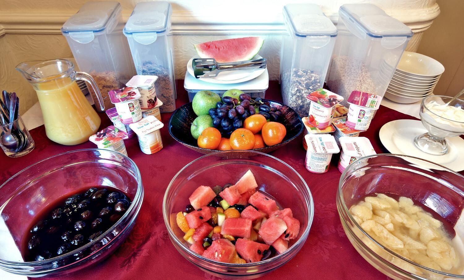 A buffet table with various food items and containers.