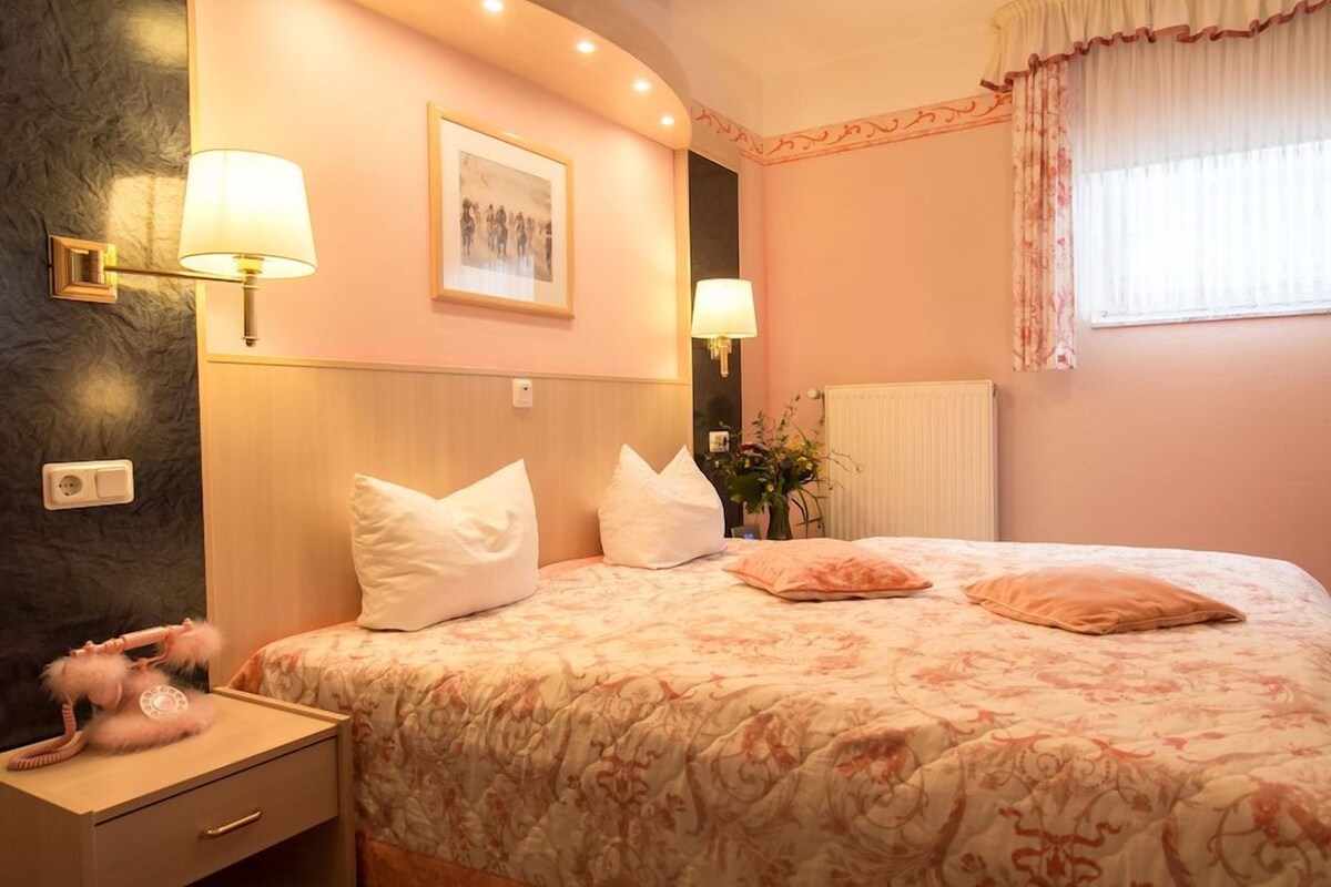 Premium bedding, desk, laptop workspace, blackout drapes