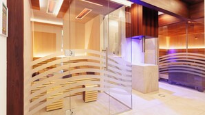 A modern interior with a glass partition, wooden slats, and a curved ceiling design. - Hotel Sonnengarten (Bad Woerishofen)