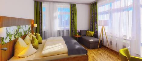 A modern hotel room with a large bed, a sofa, a small table with a lamp, and a chair.
