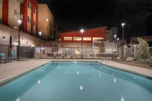 Seasonal outdoor pool, open 9 AM to 10 PM, pool umbrellas, pool loungers